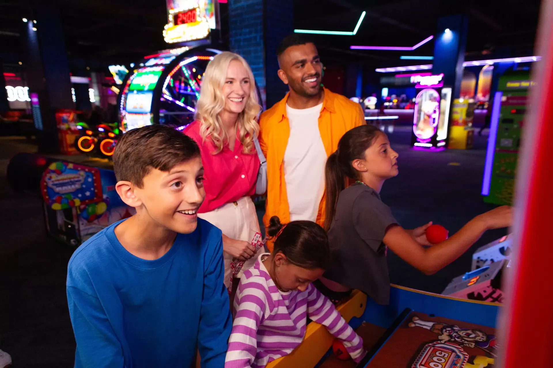 A family playing arcade games at Hollywood Bowl centre