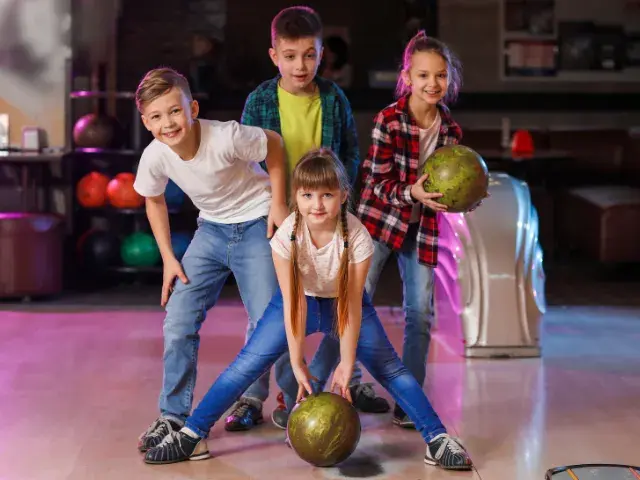 kids celebrating while bowling