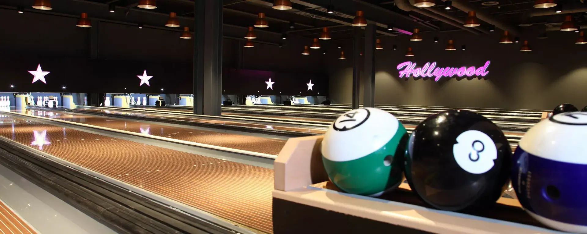 Lanes and bowling balls at Hollywood Bowl Cheltenham