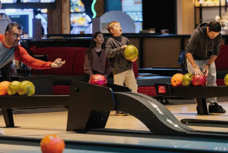 Kids bowling with their team at Splitsville Bowl