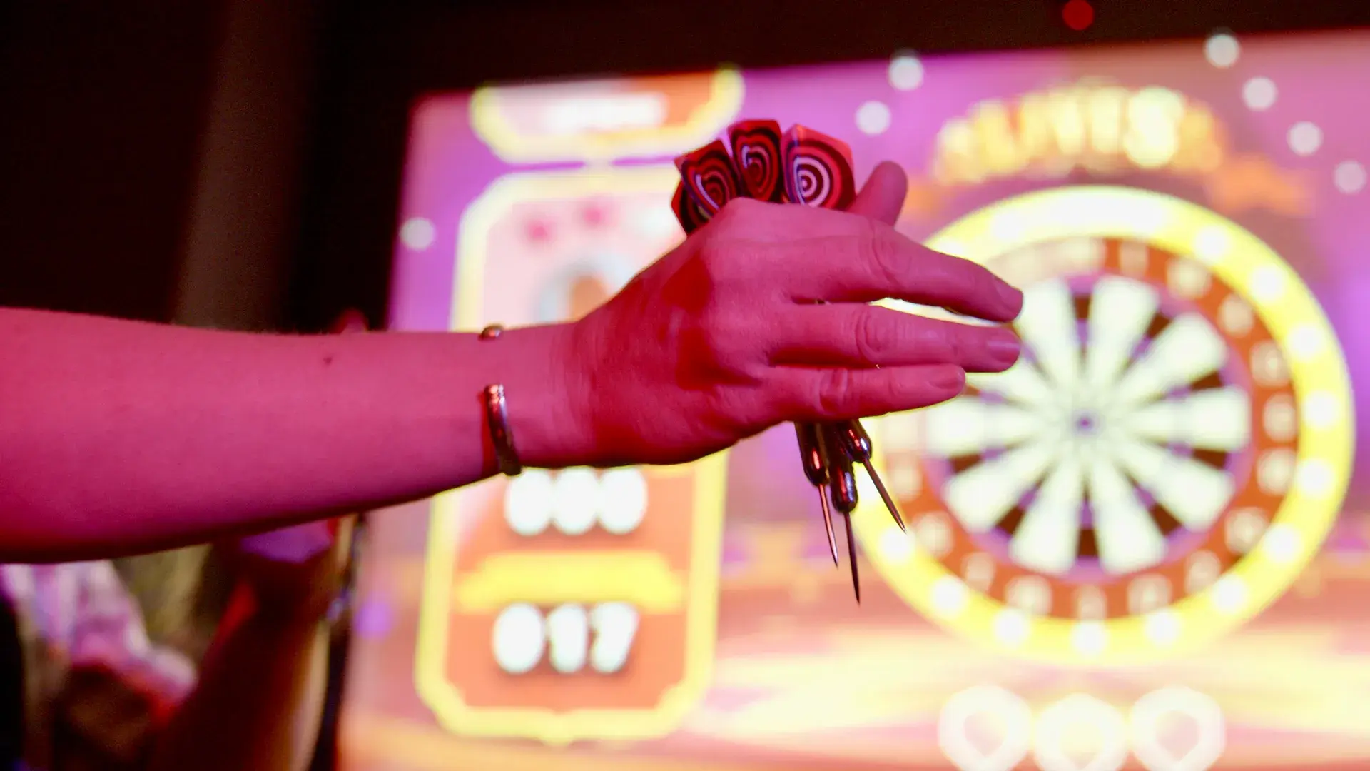 Hands holding darts