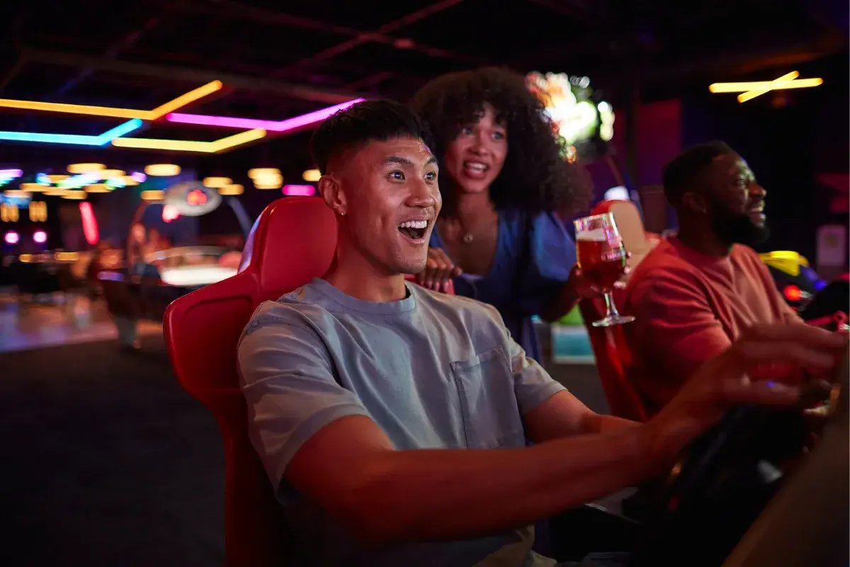 Young adults enjoying the arcade at Splitsville Bowl