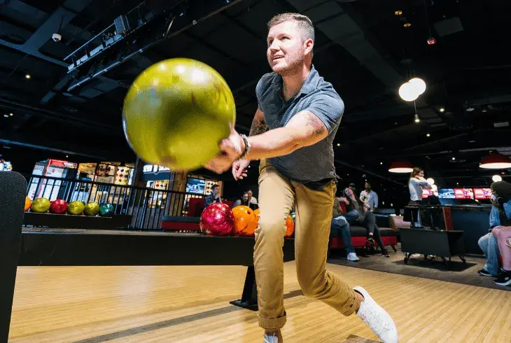 A man bowling in his own shoes at Splitsville Bowl
