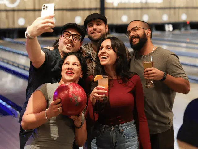A group of friends taking a selfie in a Splitsville Bowl centre