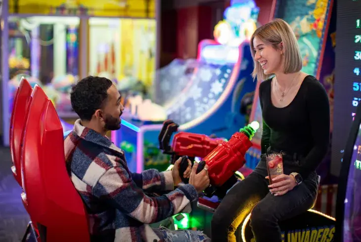 Couple in Splitsville's arcade on a date
