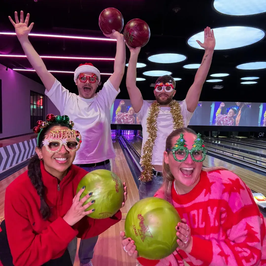 4 people xmas theme on lane with bowling balls