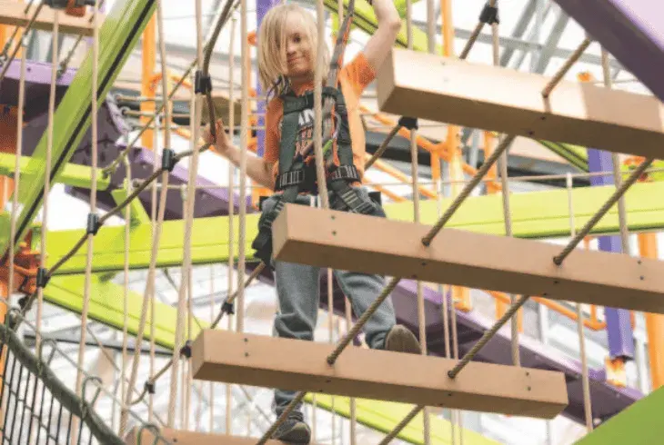 A young child reaching new heights  at Stoked by Splitsville Bowl