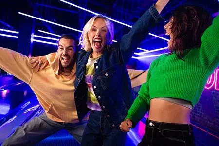 Three Young Adults Celebrating a strike at Hollywood Bowl