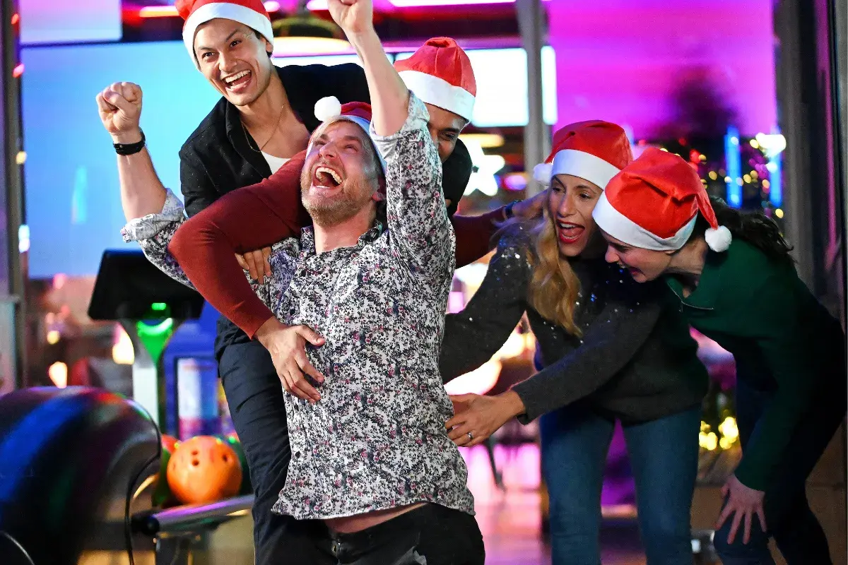 Group of friends bowling on the lanes and having fun