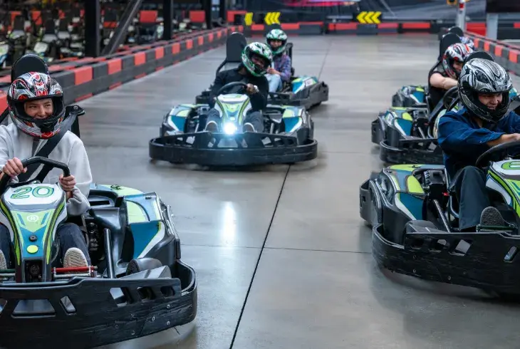 Students having a race around the track a Stoked by Splitsville Bowl