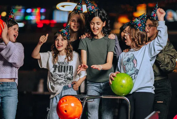 Kids having fun bowling at Stoked by Splitsville Bowl