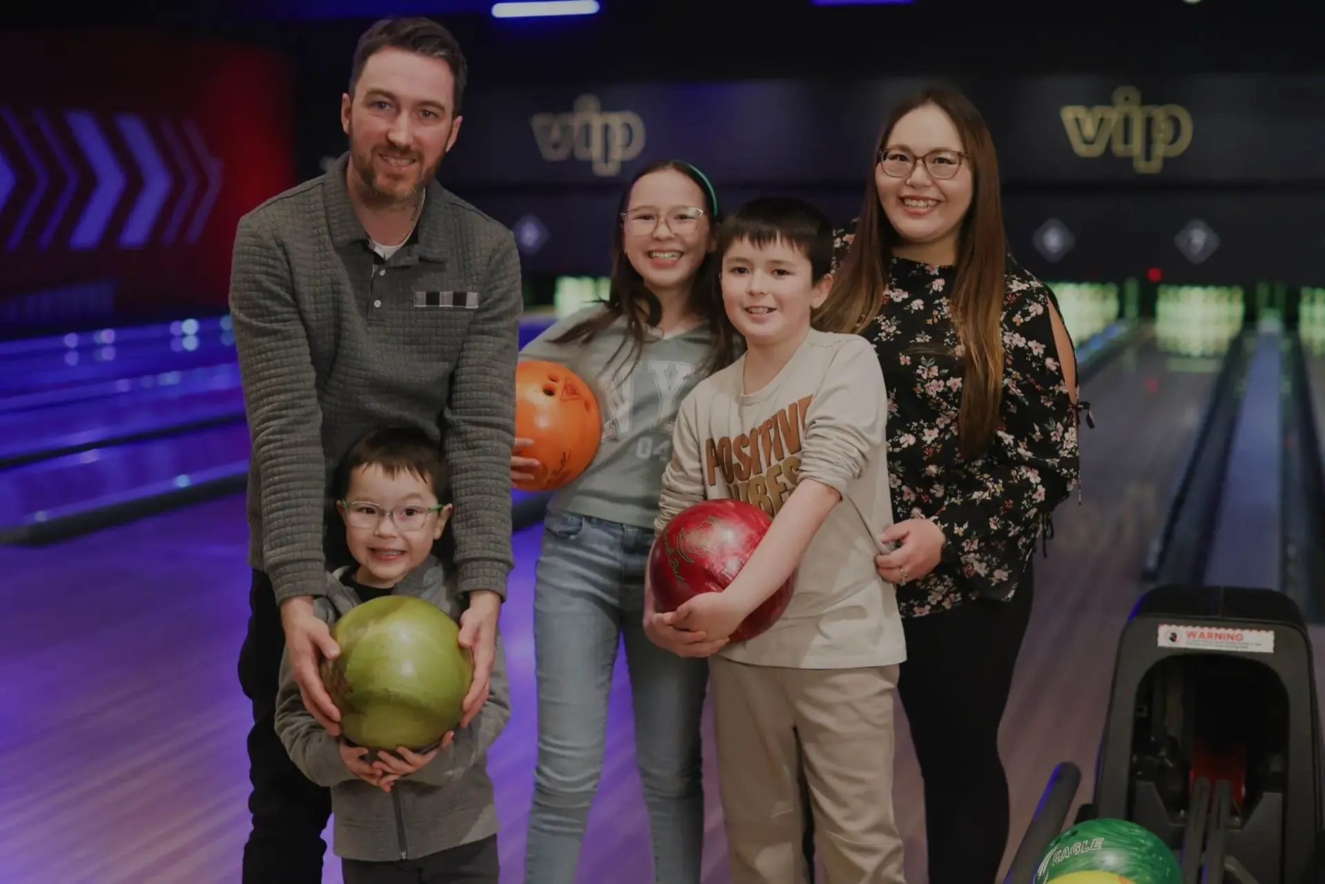 A family bowling at a Splitsville Bowl centre during the Family Fun Weekend