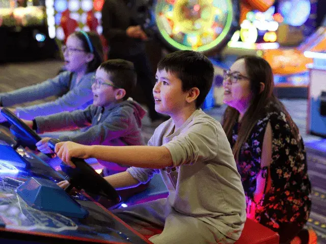 Children having fun at an arcade in a Splitsville Bowl centre