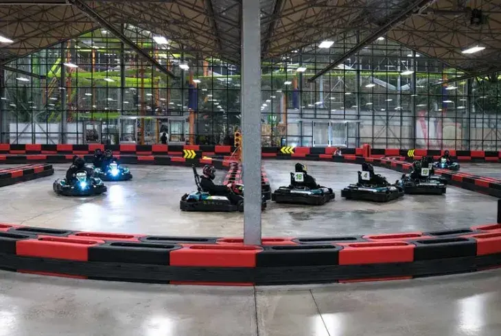 Racers  driving go karts at Stoked in Saskatoon