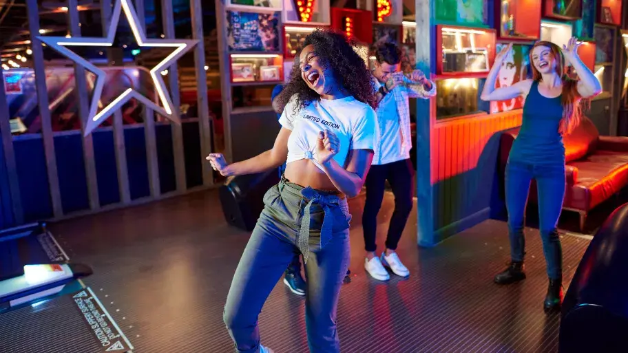 Young adult bowling a strike at Hollywood Bowl