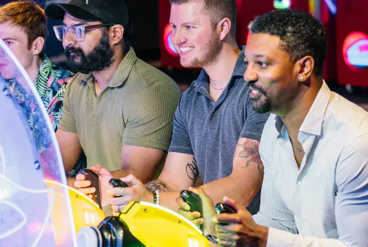 group of men playing at Splitsville's arcade