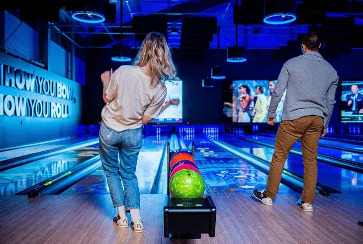 Young adults bowling at Stoked Saskatoon