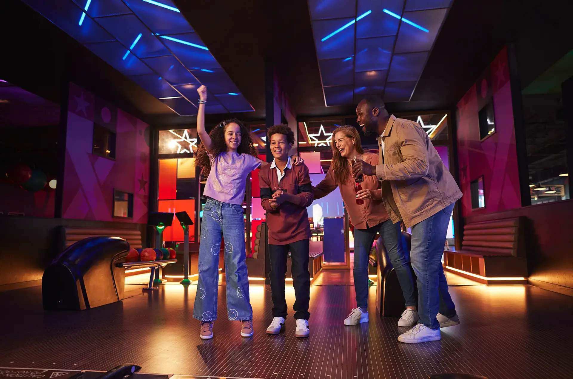 A family celebrating bowling at a Hollywood Bowl centre