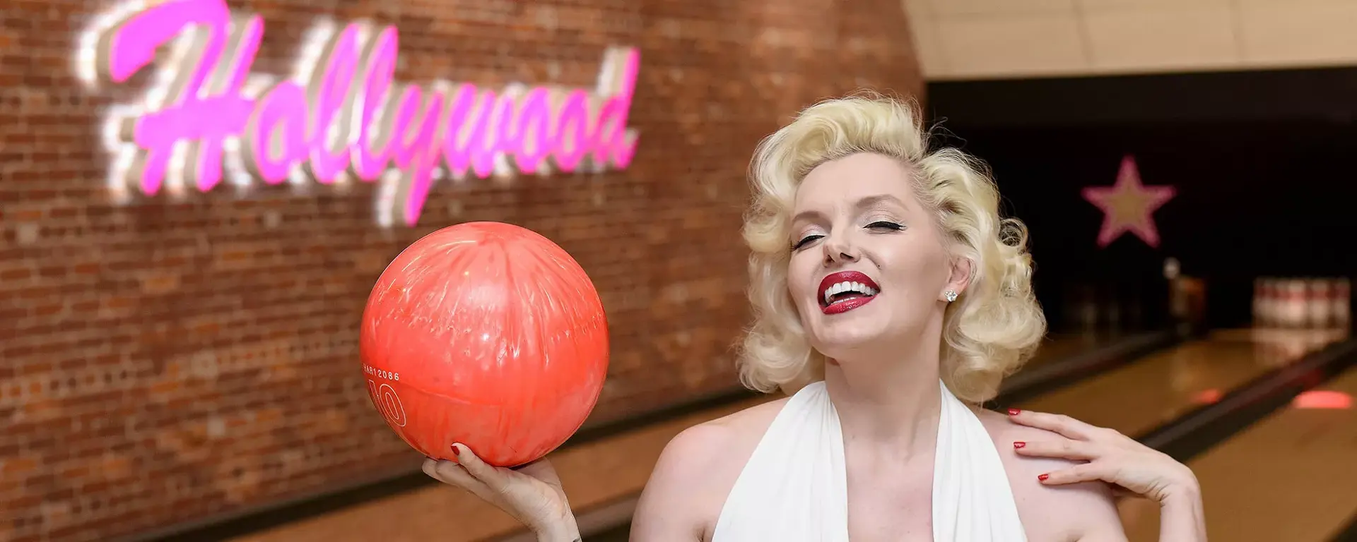 Marilyn Monroe holding a bowling ball on the lanes at Hollywood Bowl