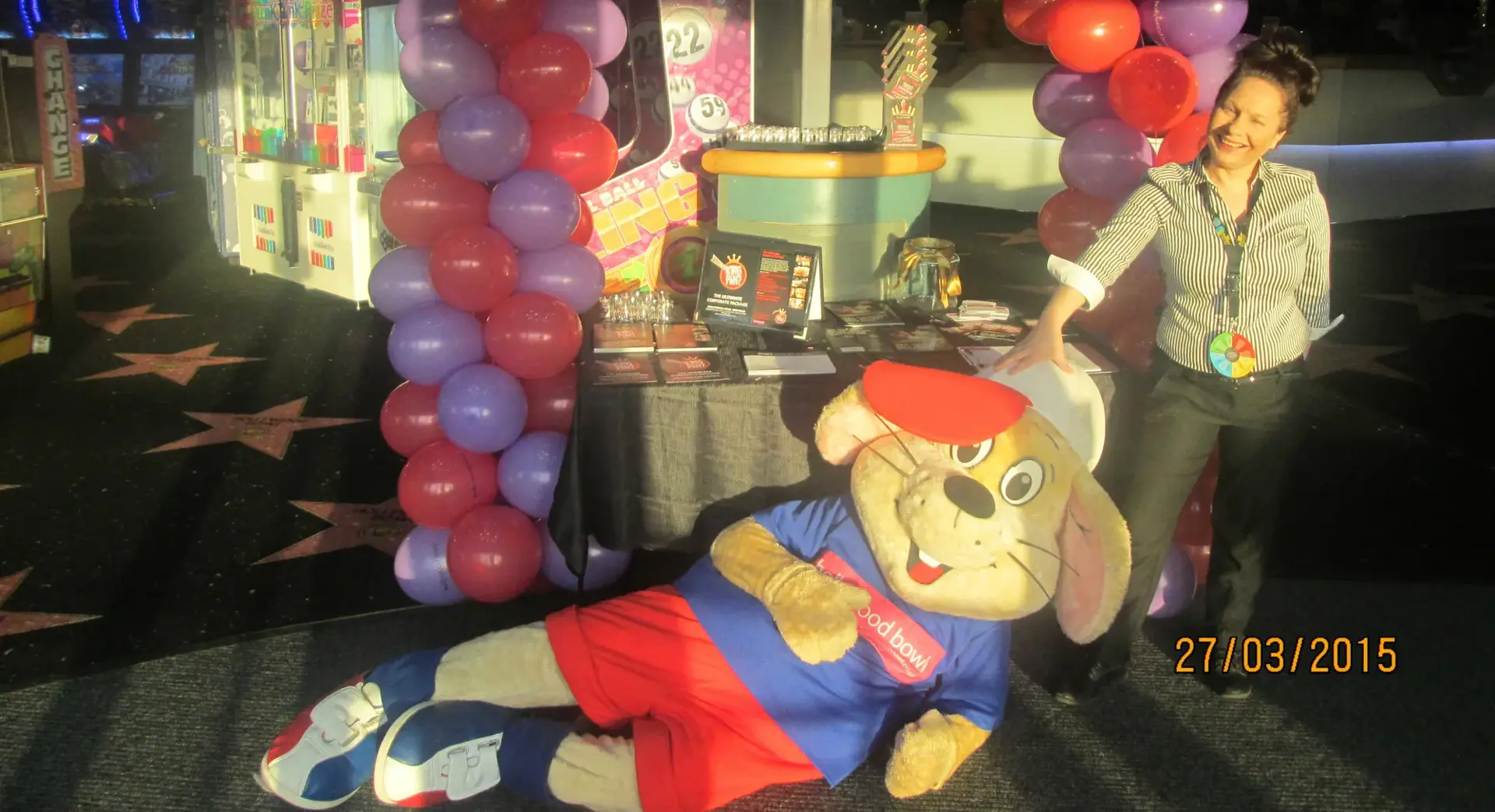 Bumper the Hollywood Bowl mascot relaxing in front of a balloon arch