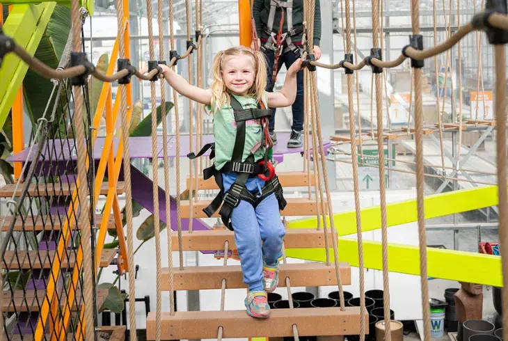 A young child using the Sky Trail at Stoked in Saskatoon