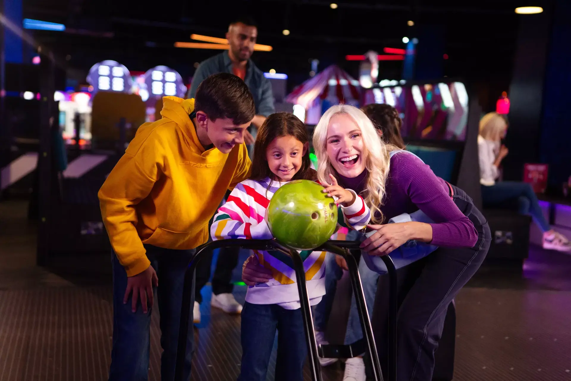 A family celebrating bowling at a Hollywood Bowl centre