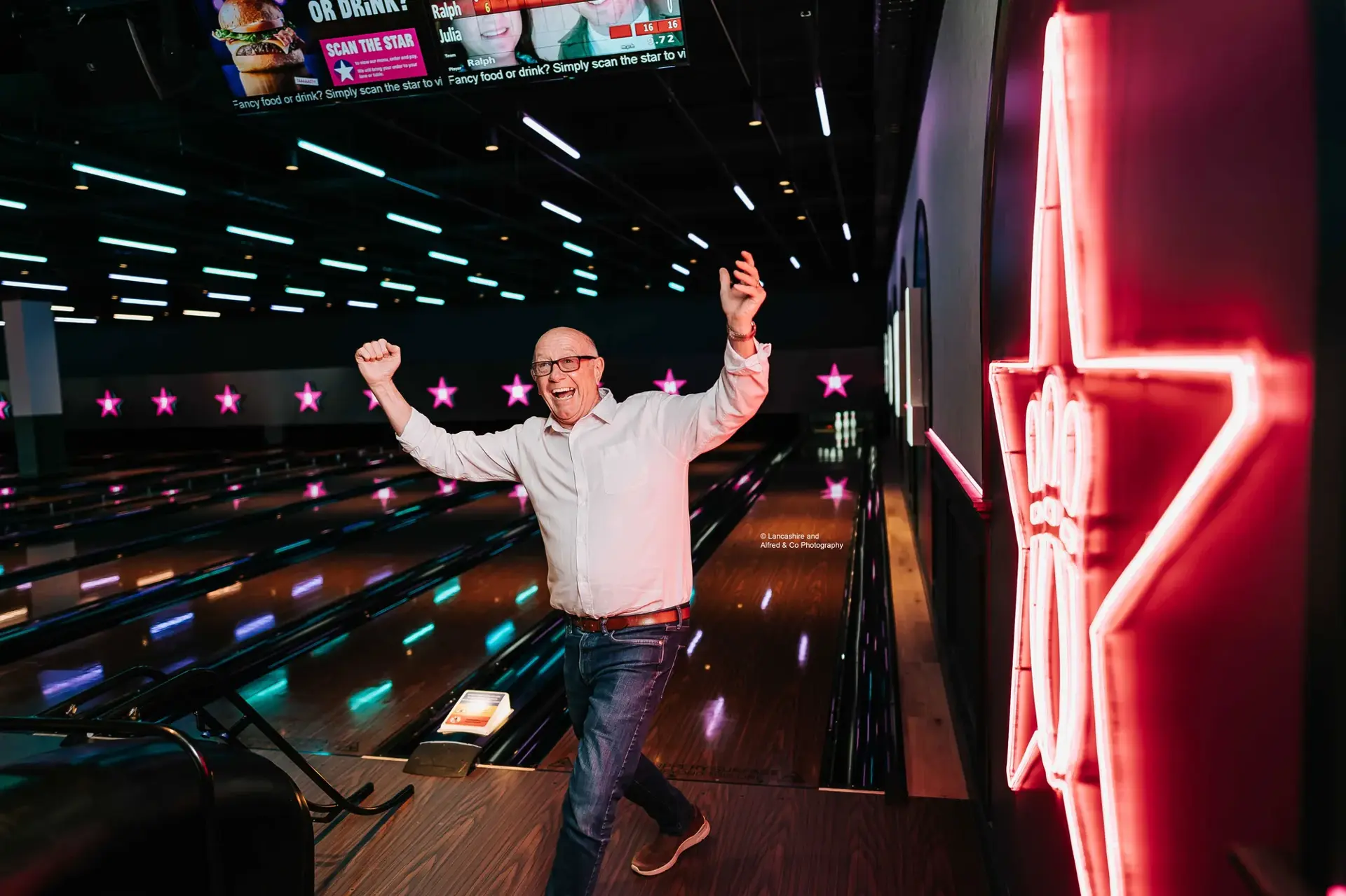 An elderly man celebrating a strike at Hollywood Bowl Preston.
